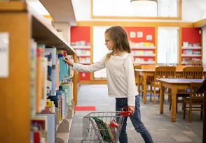 photo of girl selecting library books