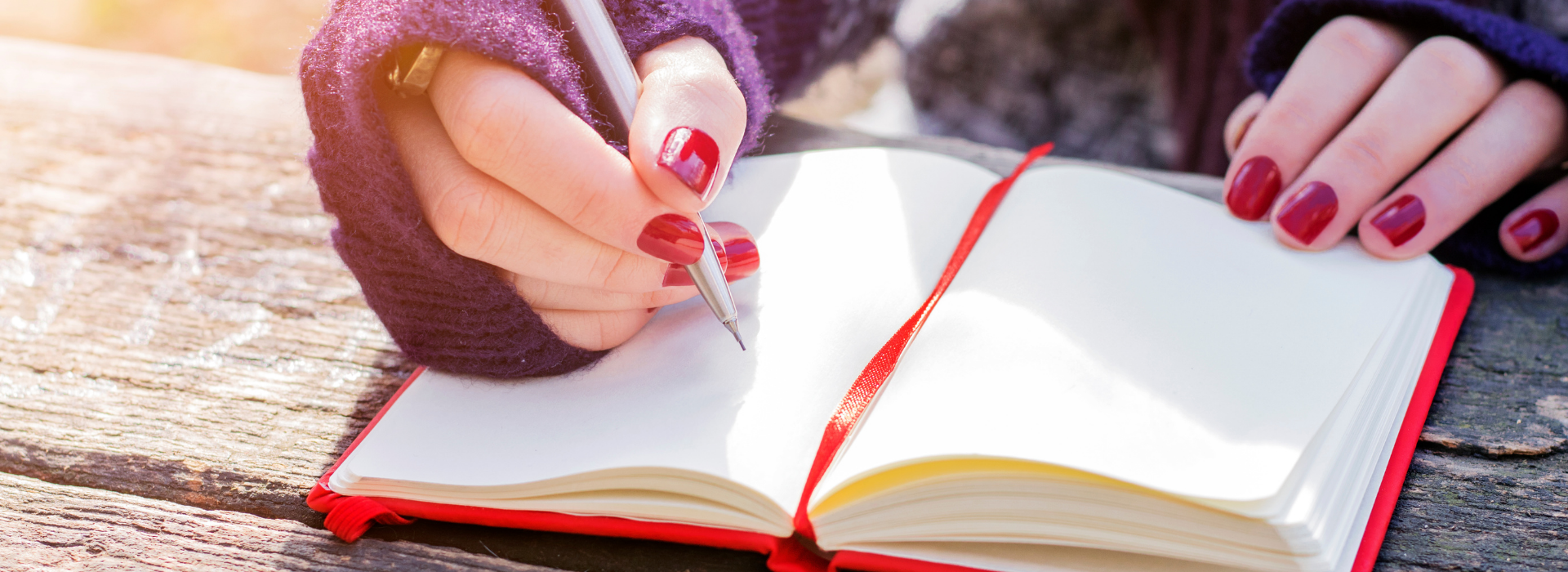 close up of hand writing in a notebook